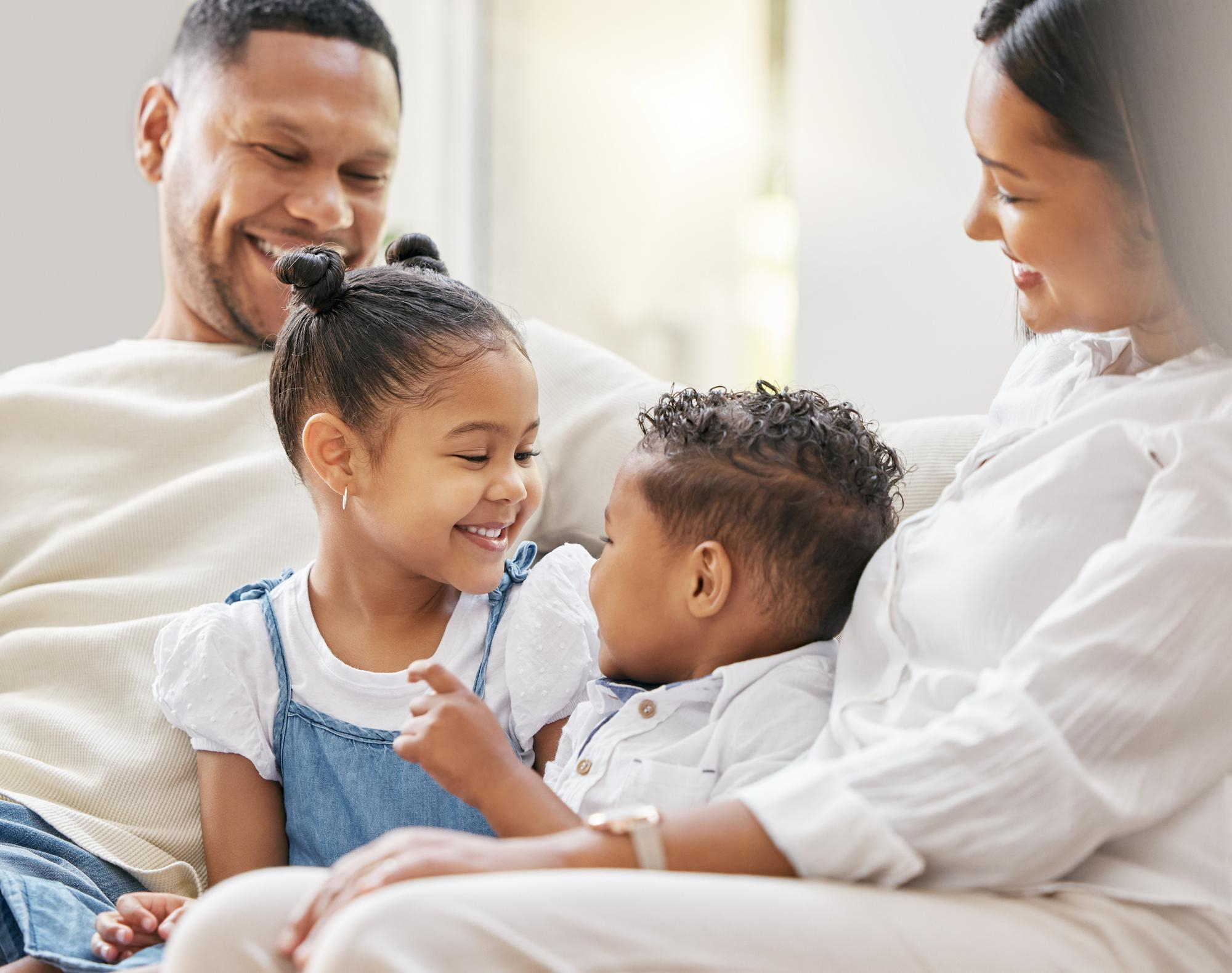 Family sitting together on a couch at home